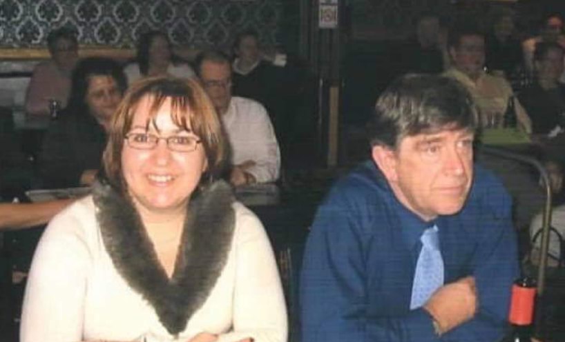 Felicia is smiling at the camera while Paddy next to her looks off camera.