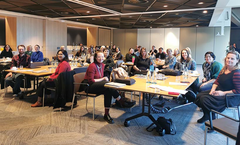 Attendees of the Community Development and Community Legal Education Working Group sitting at tables