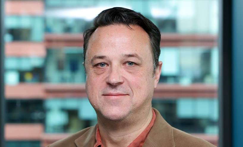 Profile photo of man with short brown hair looking at the camera.