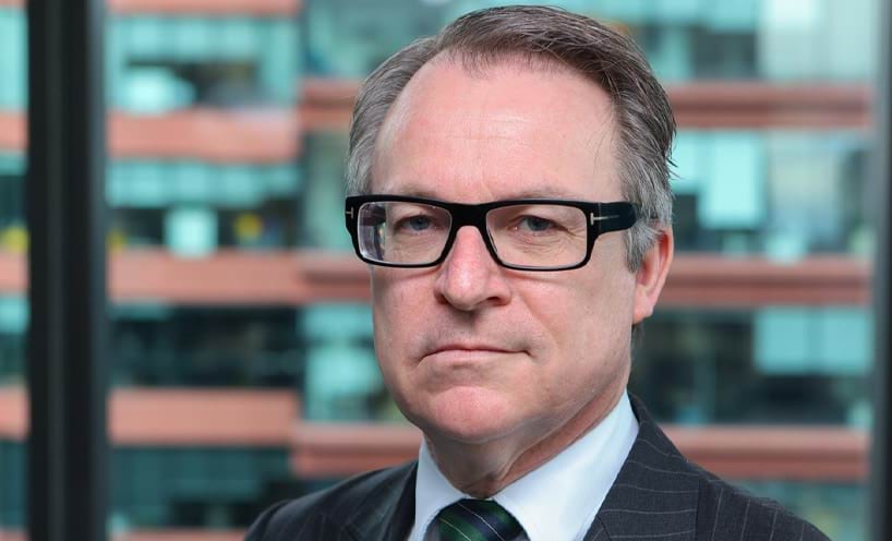 Profile photo of Daniel McGlone in suit with short grey hair and glasses.